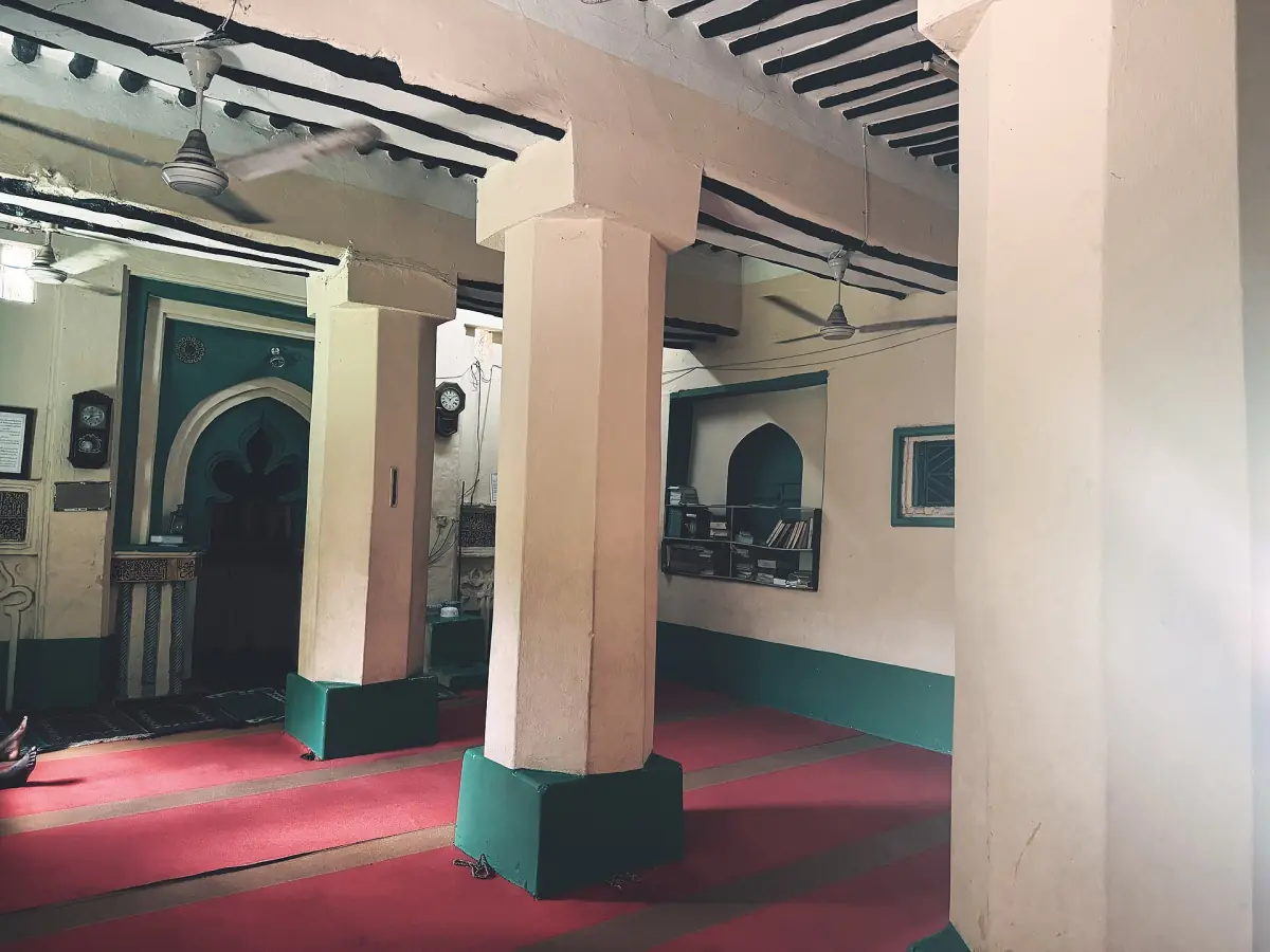 Pillared interior of the historic Kizimkazi mosque with a red carpet